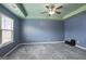 Blue bedroom with carpet, window, and ceiling fan at 2171 Grant Ave, Mcdonough, GA 30252