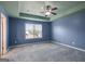 Blue bedroom with carpet, window and ceiling fan at 2171 Grant Ave, Mcdonough, GA 30252