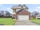 Two-story brick home with attached garage and landscaped lawn at 2171 Grant Ave, Mcdonough, GA 30252