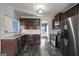 Kitchen with dark cabinets, granite countertops, and stainless steel appliances at 2171 Grant Ave, Mcdonough, GA 30252