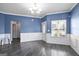 Spacious living room with hardwood floors and updated chandelier at 2171 Grant Ave, Mcdonough, GA 30252