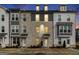 Three-story townhome with gray and white exterior, brick accents, and walkway at 295 Cobalt Dr, Fayetteville, GA 30214