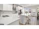 Modern kitchen with island, white cabinets, and stainless steel appliances at 295 Cobalt Dr, Fayetteville, GA 30214