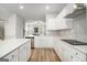 Open concept kitchen with white cabinets and a black cooktop at 295 Cobalt Dr, Fayetteville, GA 30214
