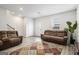 Living room with two brown couches, rug, and hardwood floors at 295 Cobalt Dr, Fayetteville, GA 30214
