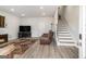 Spacious living room with fireplace, TV, and brown leather couches at 295 Cobalt Dr, Fayetteville, GA 30214