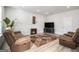 Living room with brown couches, fireplace, and large TV at 295 Cobalt Dr, Fayetteville, GA 30214