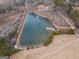 Aerial view of a beautiful pond with a charming dock and lush green surroundings at 3505 Gum Creek Rd, Oxford, GA 30054