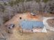 High-angle aerial view showcases a charming home and its tranquil, wooded surroundings at 3505 Gum Creek Rd, Oxford, GA 30054