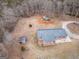 Aerial view of the home and storage structures on this wooded lot at 3505 Gum Creek Rd, Oxford, GA 30054