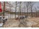 Backyard patio with outdoor chairs and a fire pit overlooking the lake at 3505 Gum Creek Rd, Oxford, GA 30054