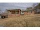 Brick home with covered deck, bay window, and gentle slope in a serene setting at 3505 Gum Creek Rd, Oxford, GA 30054