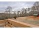 Expansive backyard view featuring a covered area, lush greenery, and serene wooded backdrop at 3505 Gum Creek Rd, Oxford, GA 30054