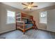 Bedroom features a bunk bed, neutral walls, and two bright windows for natural light at 3505 Gum Creek Rd, Oxford, GA 30054