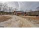Brick home showcasing a two-car garage and wooden deck, nestled on a spacious lot at 3505 Gum Creek Rd, Oxford, GA 30054
