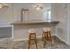 Bright kitchen featuring a bar top with seating and stone-patterned floors, perfect for casual dining at 3505 Gum Creek Rd, Oxford, GA 30054