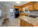 Well-lit kitchen featuring wooden cabinetry, granite countertops, and modern appliances, ideal for cooking at 3505 Gum Creek Rd, Oxford, GA 30054