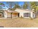 Charming single-story home with a well-maintained lawn and attached two-car garage at 210 Imad Ct, Fairburn, GA 30213