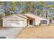 Charming single-story home with a well-maintained lawn and attached two-car garage at 210 Imad Ct, Fairburn, GA 30213