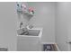 Laundry room features modern appliances and storage shelving at 210 Imad Ct, Fairburn, GA 30213