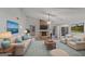 Staged living room featuring a stone fireplace, neutral furniture, and ample natural light at 210 Imad Ct, Fairburn, GA 30213