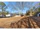 Large backyard with mature trees and partial home view at 110 Bailey Ct, Fayetteville, GA 30215