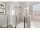 Walk-in shower with glass enclosure and tiled walls at 10462 Trellis Lane (Lot 41), Hampton, GA 30228