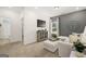 Bright bonus room features a comfortable sectional sofa and built-in shelving at 10462 Trellis Lane (Lot 41), Hampton, GA 30228