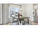 Charming breakfast nook with a round table and black and white chairs at 10462 Trellis Lane (Lot 41), Hampton, GA 30228