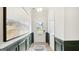 Elegant entryway with green wainscoting and a large piece of art at 10462 Trellis Lane (Lot 41), Hampton, GA 30228