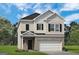 Two-story house with light beige vinyl siding, brown roof, and a two-car garage at 10462 Trellis Lane (Lot 41), Hampton, GA 30228