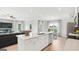 Spacious kitchen island with white cabinets and a view into the living room at 10462 Trellis Lane (Lot 41), Hampton, GA 30228