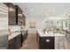 Open concept kitchen with island, stainless steel appliances and dark brown cabinets at 10462 Trellis Lane (Lot 41), Hampton, GA 30228
