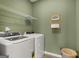 Laundry room with a washer, dryer, and overhead shelving at 10462 Trellis Lane (Lot 41), Hampton, GA 30228