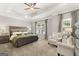 Main bedroom with two armchairs and large windows at 10462 Trellis Lane (Lot 41), Hampton, GA 30228