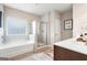 Elegant bathroom with a soaking tub, shower, and double vanity at 1480 Trellis Court (Lot 42), Hampton, GA 30228