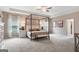 Spacious primary bedroom with a canopy bed and neutral decor at 1480 Trellis Court (Lot 42), Hampton, GA 30228