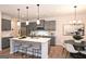 Stylish kitchen boasting gray cabinets, a large island, and breakfast nook at 1480 Trellis Court (Lot 42), Hampton, GA 30228
