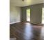 Spacious bedroom with wood-look flooring and large windows at 2522 Horseshoe Bend Sw Rd, Marietta, GA 30064