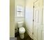 Simple bathroom with white toilet and wood-look floors at 1279 Allene Sw Ave, Atlanta, GA 30310