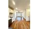 Open concept living and kitchen area with hardwood floors and white cabinets at 1279 Allene Sw Ave, Atlanta, GA 30310