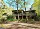 Two story house with large deck and screened porch, nestled in a wooded area at 500 Augusta Ln, Chattahoochee Hills, GA 30268