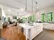 Open concept kitchen with marble island and views into the living room at 500 Augusta Ln, Chattahoochee Hills, GA 30268