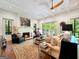 Spacious living room with fireplace, large windows and access to a deck at 500 Augusta Ln, Chattahoochee Hills, GA 30268