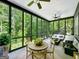 Relaxing screened porch with seating area and wooded views at 500 Augusta Ln, Chattahoochee Hills, GA 30268