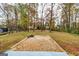 Brick patio and fire pit in a wooded backyard at 2994 Meadow Wood Ct, Lawrenceville, GA 30044