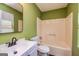 Clean bathroom with tub, toilet, sink, and mirror at 2994 Meadow Wood Ct, Lawrenceville, GA 30044