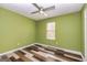 Bright bedroom with ceiling fan, wood-look flooring, and large window at 2994 Meadow Wood Ct, Lawrenceville, GA 30044