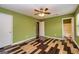 Bedroom with ceiling fan, wood-look floors, and access to bathroom at 2994 Meadow Wood Ct, Lawrenceville, GA 30044