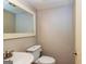 Small bathroom with toilet, sink, and decorative mirror at 172 Twiggs Cor, Peachtree City, GA 30269